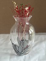 Front view of clear glass vase showing pewter tulip relief