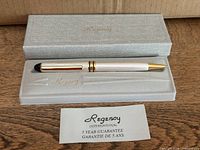 Pen in open case with guarantee card visible