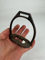 Front view of the iron stirrup showing strap slot and tread plate