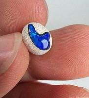 Close-up of opal face showing color play and matrix setting