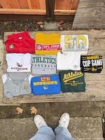 Top view of all shirts laid out on wooden surface