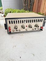 Front three-quarter view of Heathkit IG-57A showing full control panel, enclosure and connectors