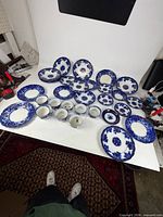 Entire 32-piece Waldorf flow blue porcelain service laid out