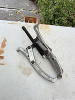 Overall view of bearing puller showing two jaws and center screw