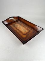 Oblique view showing overall shape, wood grain, and one handle