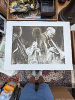 Full view of unframed print on floor showing entire image and paper borders