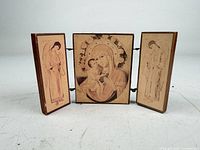 Triptych open showing front religious images