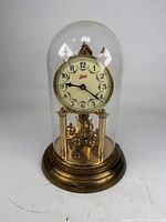 Full view of clock under glass dome