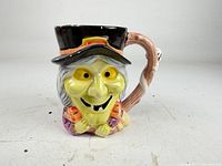 Front view of witch mug showing facial details and top hat