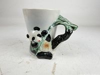 Full view of mug showing panda and bamboo handle