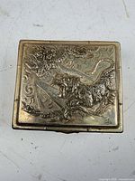 top view showing ornate dragon and tiger relief and Parker signature