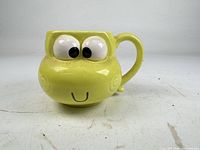 Front view of Keroppi face mug showing eyes, mouth, overall shape and color