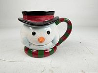 Front view of ceramic snowman coffee mug