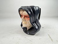 Front three-quarter view showing sculpted face and hood details