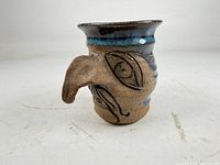 Front view showing protruding sculpted nose and eye detailing