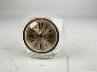 Front view showing full clock face, numerals, and acrylic case