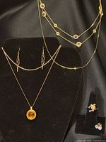 Full lot on display stand showing necklace, both earring pairs and ring