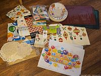 Overview of all assorted party supplies laid out on floor