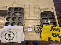 Group shot of muffin pan, mini loaf pan, four racks, apron