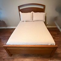 Full view of bed frame with mattress and pillows