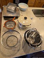 overview of all cookware, bakeware and strainers on countertop