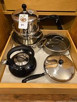 Group of cookware and kettle in drawer