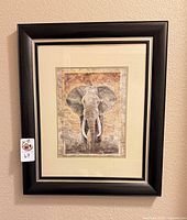 Front view of framed elephant print showing artwork, mat, and frame