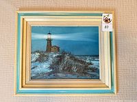 Front view of framed lighthouse oil painting