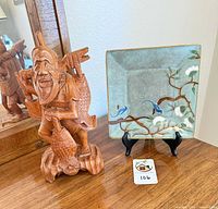 Wood sculpture, ceramic plate on easel together