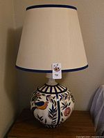 Full view of lamp with shade showing design and tag