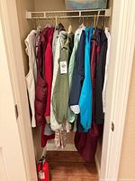 All outerwear pieces hanging in closet showing colours and types