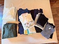 Multiple stacks of folded women’s tank tops in various colours