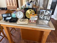 Group shot of all eight clocks on countertop