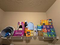 Shelf with boxed trash bags, detergent, tissues and cleaning supplies