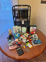 Full lot on table showing file cart loaded with hanging folders and spread of assorted supplies