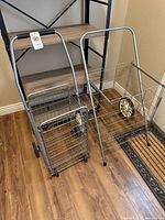 Both carts folded and upright showing fronts and wheels