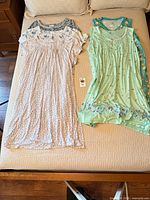 Five nightgowns laid out on bed