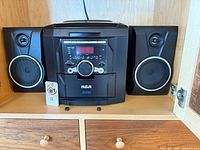 Front view showing RCA mini stereo main unit with both speakers