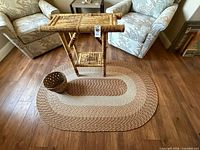 Bamboo side table on braided rug with basket nearby