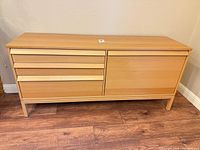 Front view showing drawers and cabinet door