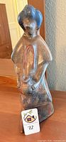 Front view of repaired ceramic figurine standing on table