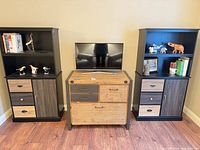 Full view showing two tall cabinets flanking small dresser