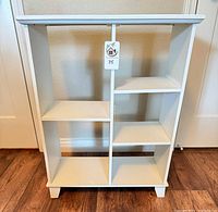 Front view of white bookcase showing five compartments