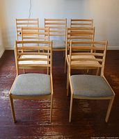 All seven matching wooden dining chairs front view