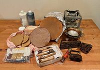 Group shot of all batik supplies including wax stove, wax blocks, dyes, canting tools, pans, pigment packets