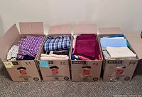 Four open Home Depot boxes labelled F1-F4 filled with folded fabric pieces.