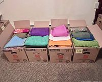 Four open boxes labeled F9-F12 containing folded fabrics