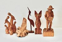 Group shot displaying all five wooden sculptures