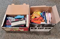 Two boxes filled with assorted ribbon and trims