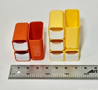 Orange and yellow pen holders side by side with ruler for scale